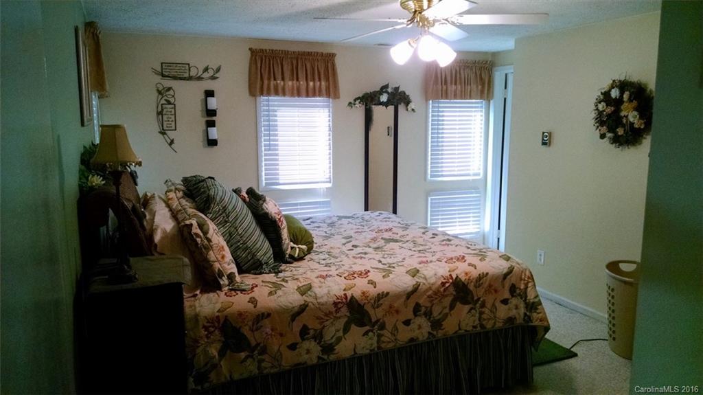 1978 Ridge Road Hendersonville, NC 28792 - Photo 6 of 18 a bedroom with a bed and a chandelier