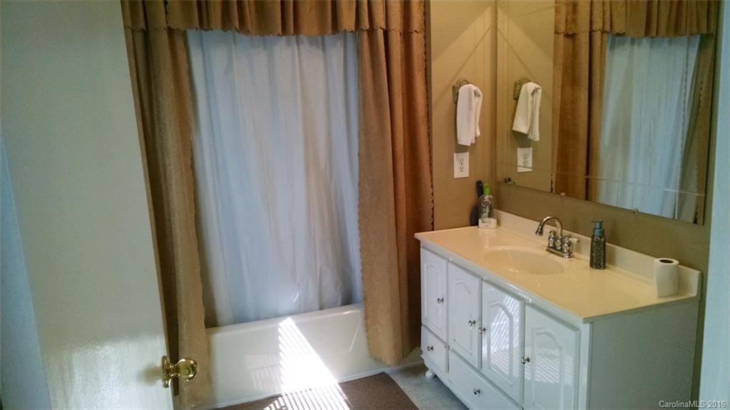1978 Ridge Road Hendersonville, NC 28792 - Photo 7 of 18 a bathroom with a sink a mirror and a shower