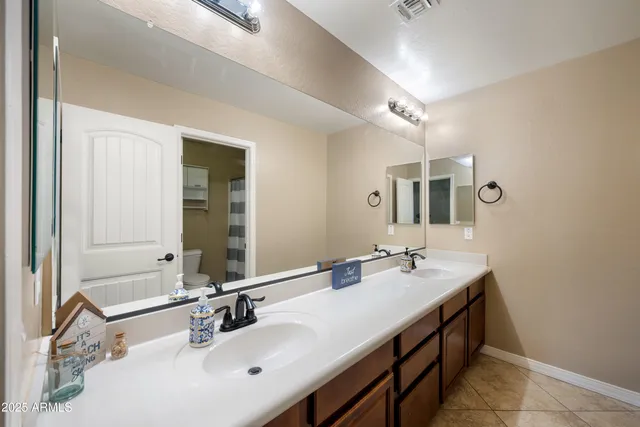 a bathroom with a sink double vanity and a mirror