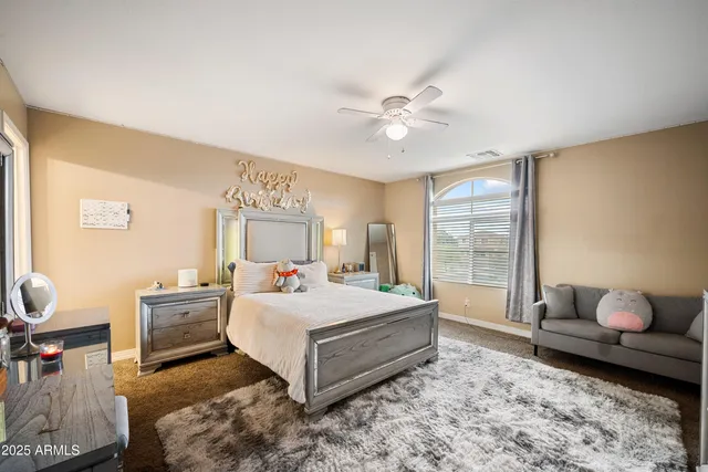 a spacious bedroom with a bed and window