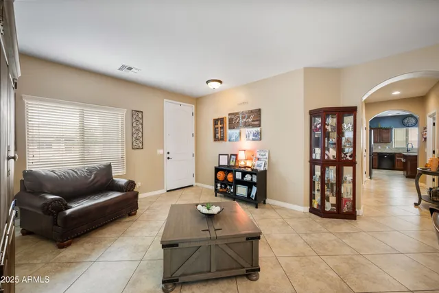 a living room with furniture and hard wood flooring