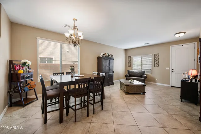 a view of a dining room with furniture and chandelier