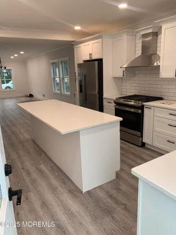 a kitchen with stainless steel appliances a refrigerator sink and stove
