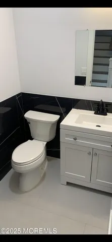 a bathroom with a toilet a sink and dishwasher