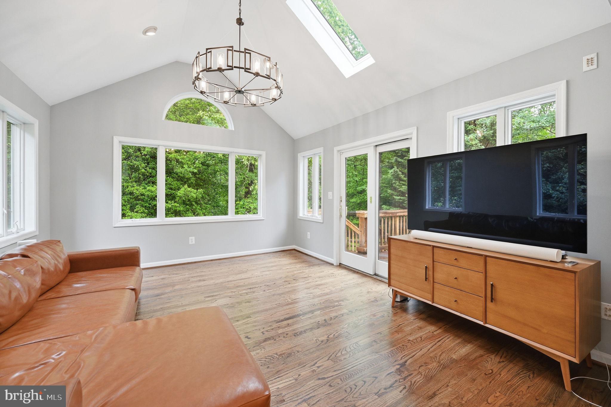 2506 Pinoak Lane Reston, VA 20191 - Photo 8 of 33 a living room with furniture a flat screen tv and a chandelier