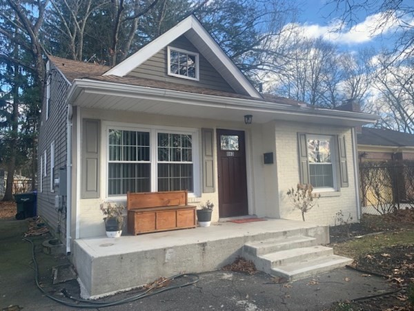 863 Roosevelt Avenue Springfield, MA 01109 - Photo 1 of 18 a front view of a house with a yard outdoor seating and garage