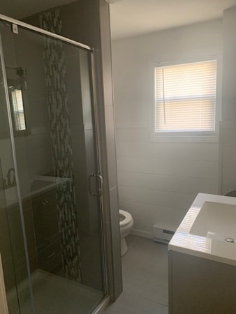 863 Roosevelt Avenue Springfield, MA 01109 - Photo 16 of 18 a bathroom with a granite countertop sink toilet and shower