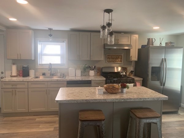 863 Roosevelt Avenue Springfield, MA 01109 - Photo 3 of 18 a kitchen with kitchen island granite countertop a sink cabinets and refrigerator