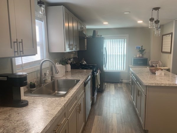 863 Roosevelt Avenue Springfield, MA 01109 - Photo 4 of 18 a kitchen with sink a window and wooden floor