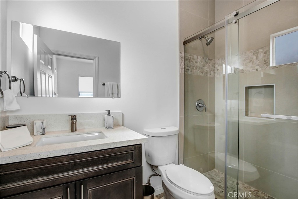 66604 Estrella Avenue, Unit CASITA Desert Hot Springs, CA 92240 - Photo 4 of 6 a bathroom with a sink a toilet and shower