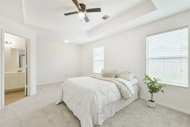 a bedroom with a bed and a potted plant