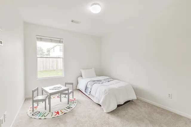 a bedroom with a bed and a chair