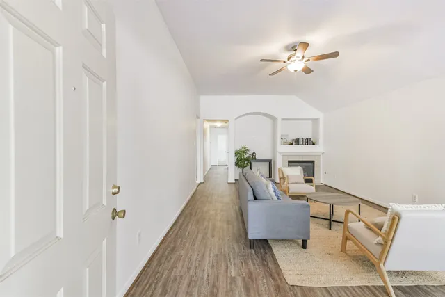 a living room with furniture and a wooden floor