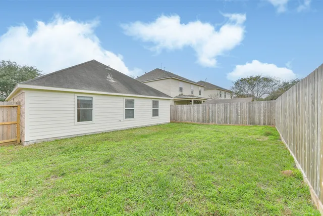 a view of a backyard with plants and a yard
