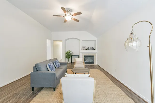 a living room with furniture and a fireplace