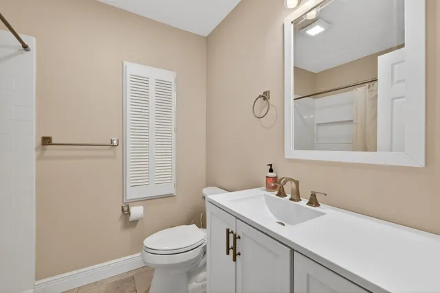 a bathroom with a sink toilet and mirror
