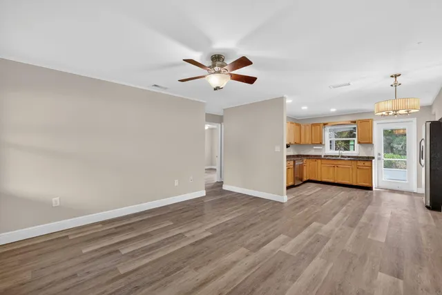 a view of a kitchen with a dishwasher and wooden floor