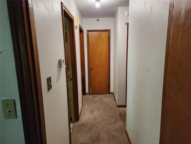 a view of a closet with wooden floor