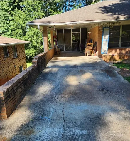 a front view of a house with a yard and glass windows