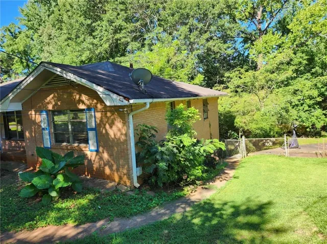 a view of a backyard with table and chairs under an umbrella