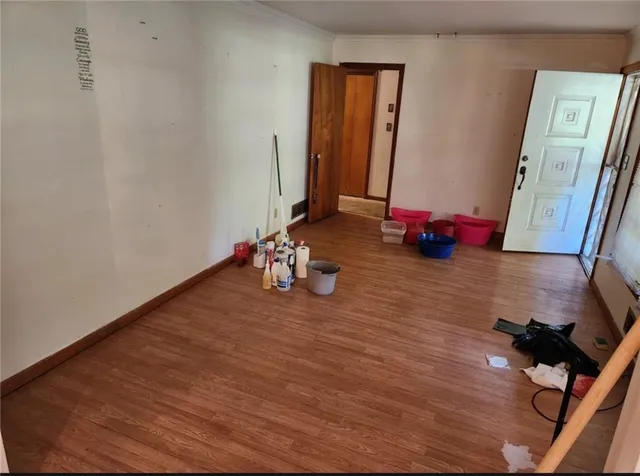 a room with wooden floor and glass door