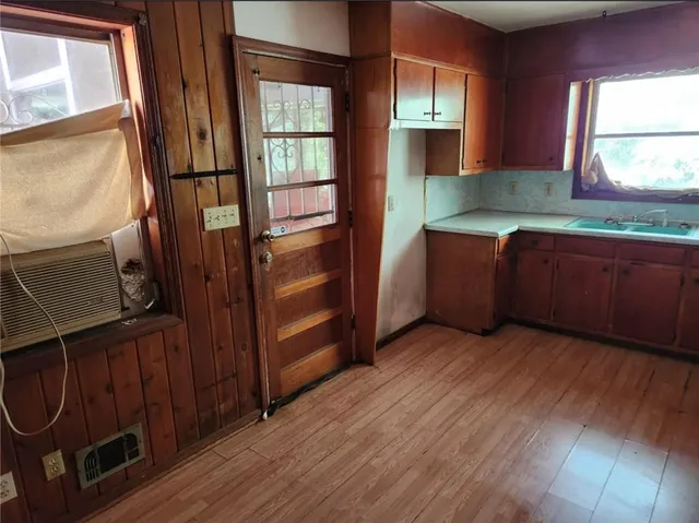 a room with wooden floors and window