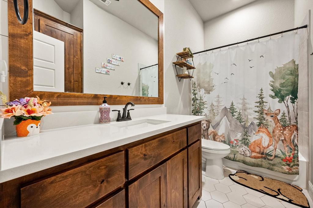 6365 Rhoden Avenue Godley, TX 76044 - Photo 23 of 31 a bathroom with a sink and a mirror