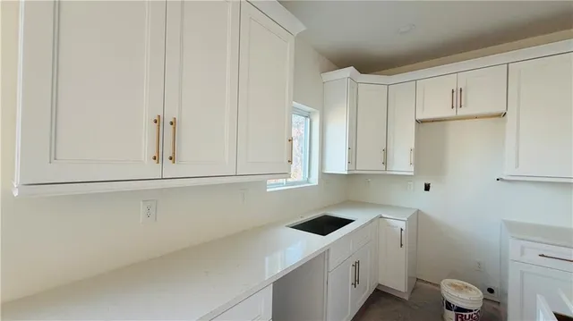 a room with a sink and cabinets