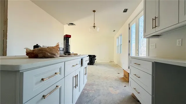 a kitchen with cabinets and window