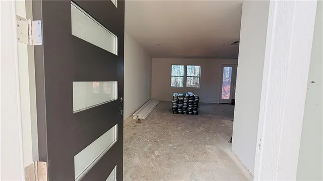 a view of livingroom with furniture and front door