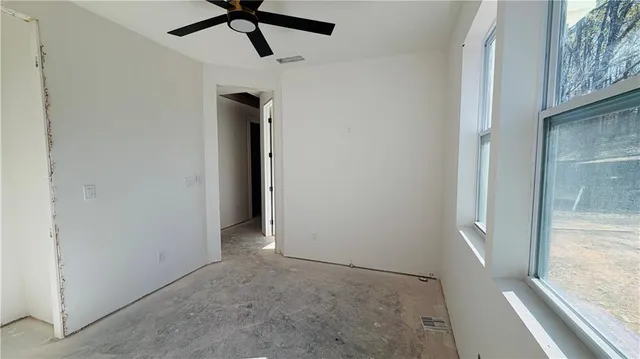 a view of hallway with a ceiling fan