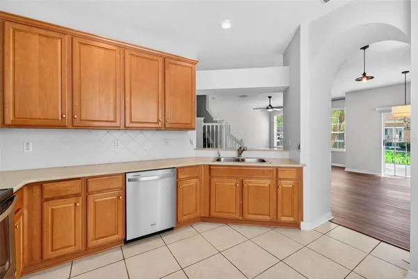a kitchen with stainless steel appliances granite countertop a sink and dishwasher with white cabinets