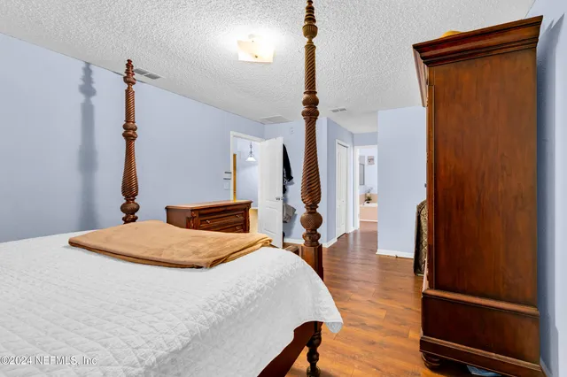 a bedroom with a bed and a dresser