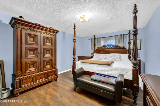 a bedroom with furniture and wooden floor