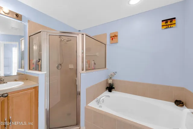 a bathroom with a bathtub and a shower