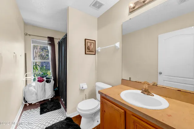 a bathroom with a sink toilet and a mirror