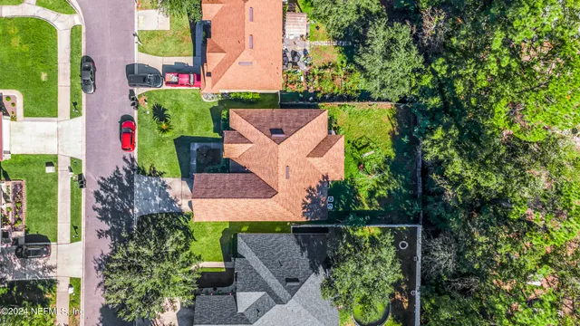 an aerial view of house with a yard and seating area