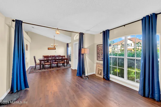 a room with furniture and a floor to ceiling window