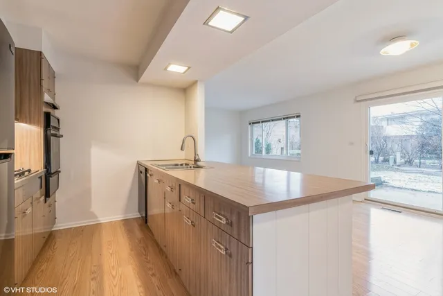 a bathroom with a granite countertop sink a large mirror and a bathtub