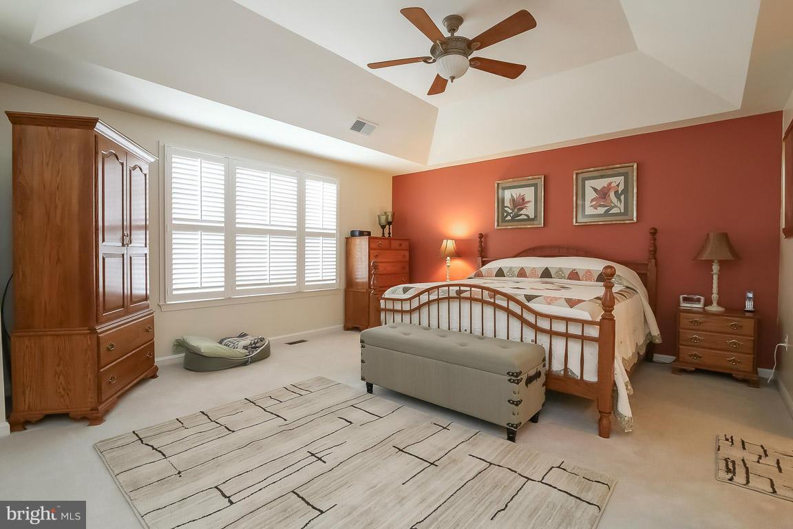 12000 Coloriver Road Manassas, VA 20112 - Photo 14 of 30 a spacious bedroom with a bed a chandelier and a window