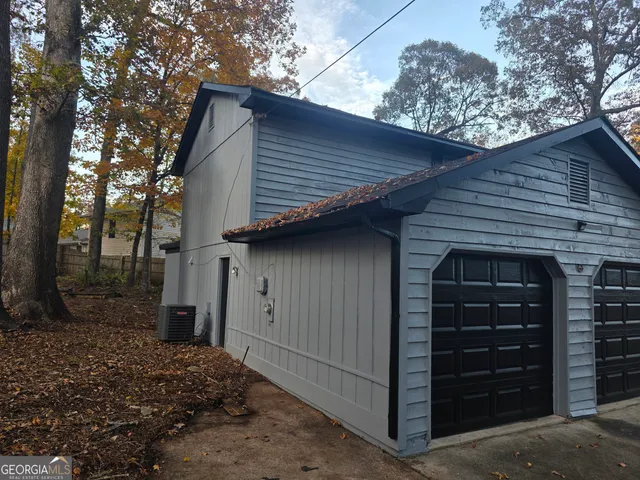 a front view of a house with a tree