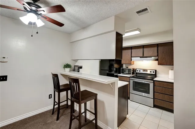 a kitchen with appliances cabinets and a counter top space