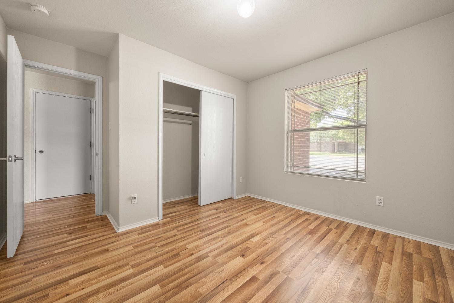 359 Spring Branch Loop Kyle, TX 78640 - Photo 14 of 17 a view of an empty room with wooden floor and a window