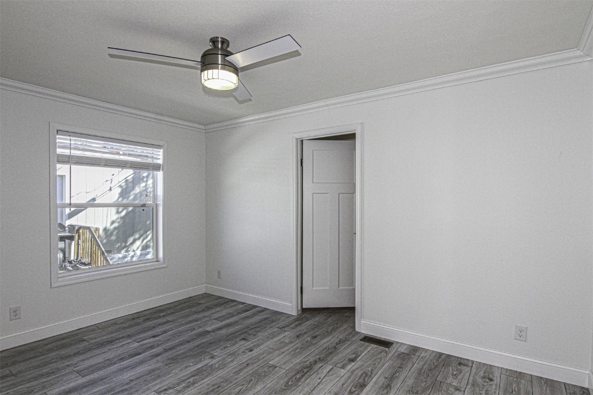 847 Airport Road, Unit 12 Breckenridge, CO 80424 - Photo 9 of 32 an empty room with wooden floor chandelier fan and windows