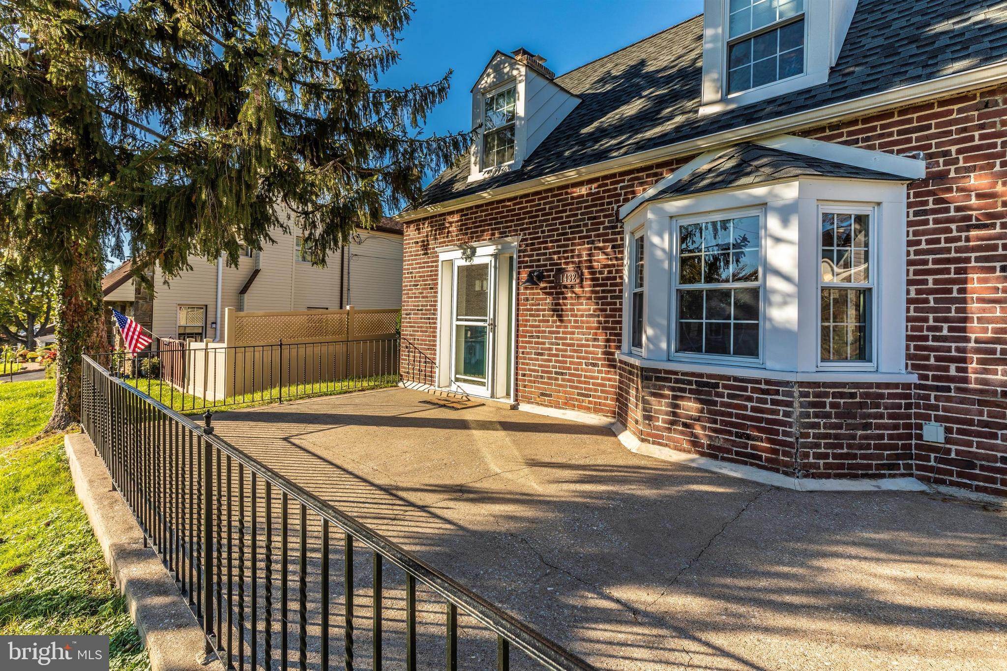 1432 Burmont Road Havertown, PA 19083 - Photo 22 of 28 a view of a brick house with large windows