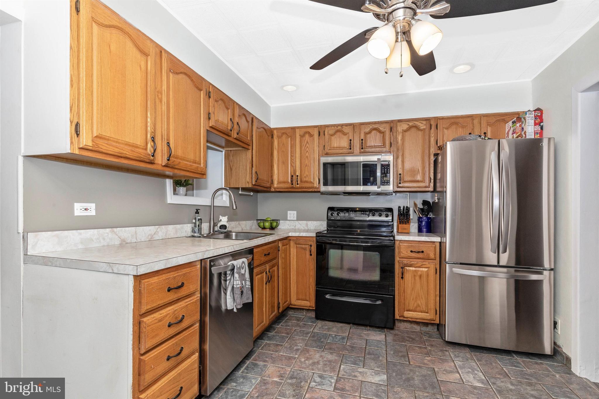 1432 Burmont Road Havertown, PA 19083 - Photo 8 of 28 a kitchen with stainless steel appliances granite countertop a refrigerator a stove a sink and a microwave