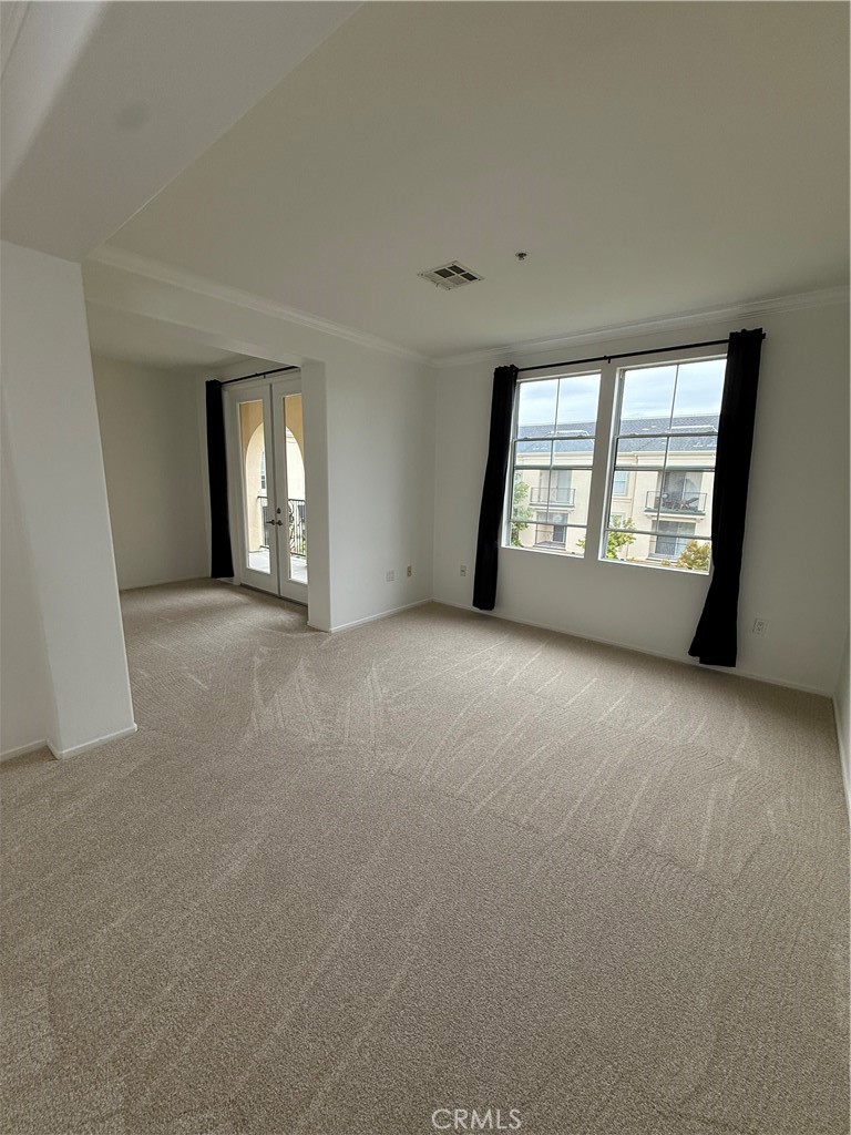 2457 Watermarke Place Irvine, CA 92612 - Photo 6 of 13 an empty room with windows