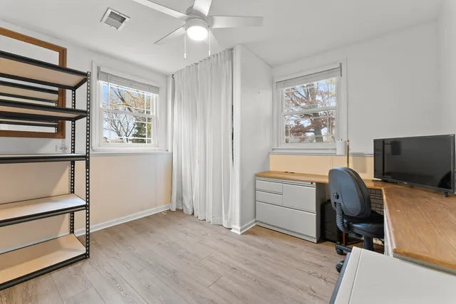 a view of workspace with wooden floor and windows