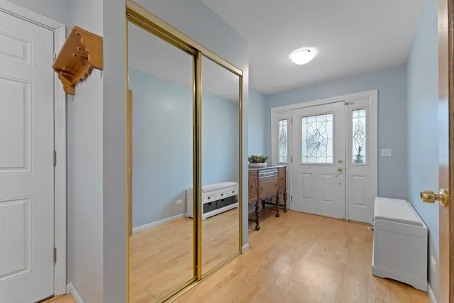 a view of a room that has a bed and a chair in it