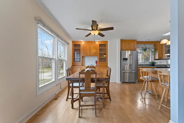 a dining room with furniture a chandelier and wooden floor